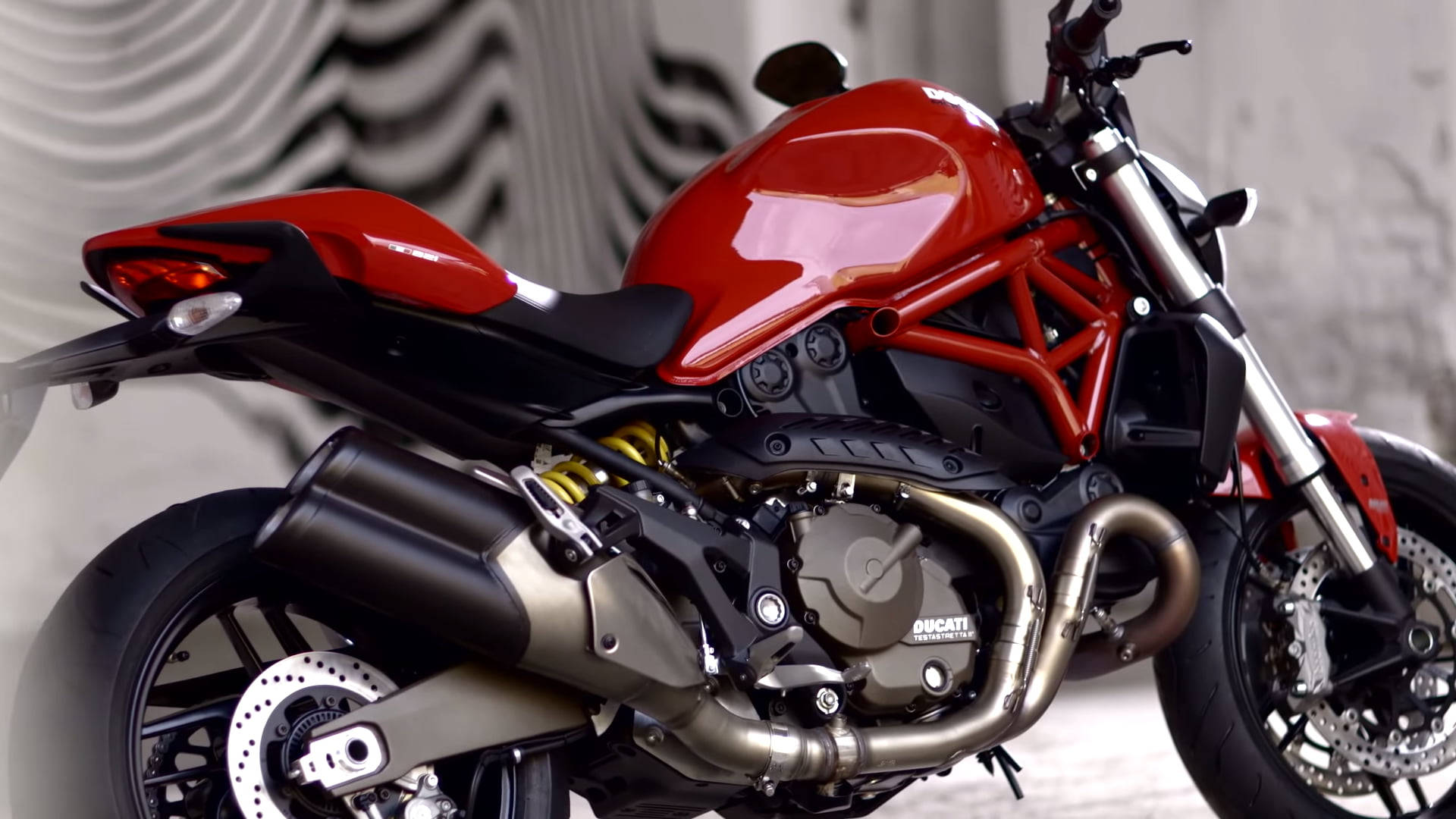 紅色Ducati電單車，露出引擎和鍍鉻排氣管。