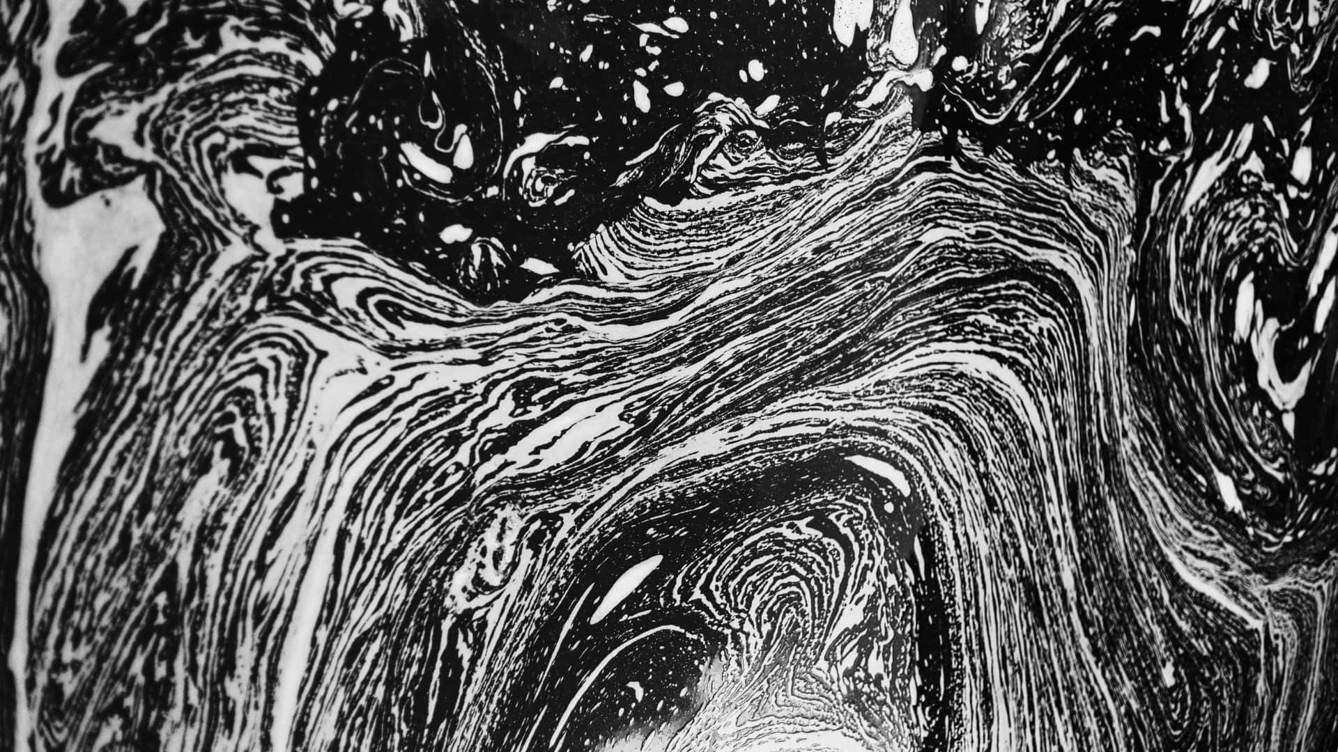 壁紙 — 動態的黑白抽象墨水和顏料漩渦，產生流體漩渦效果。