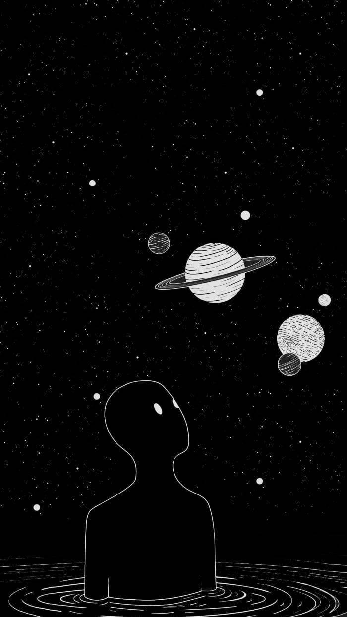 水中人物的剪影仰望行星和星星。