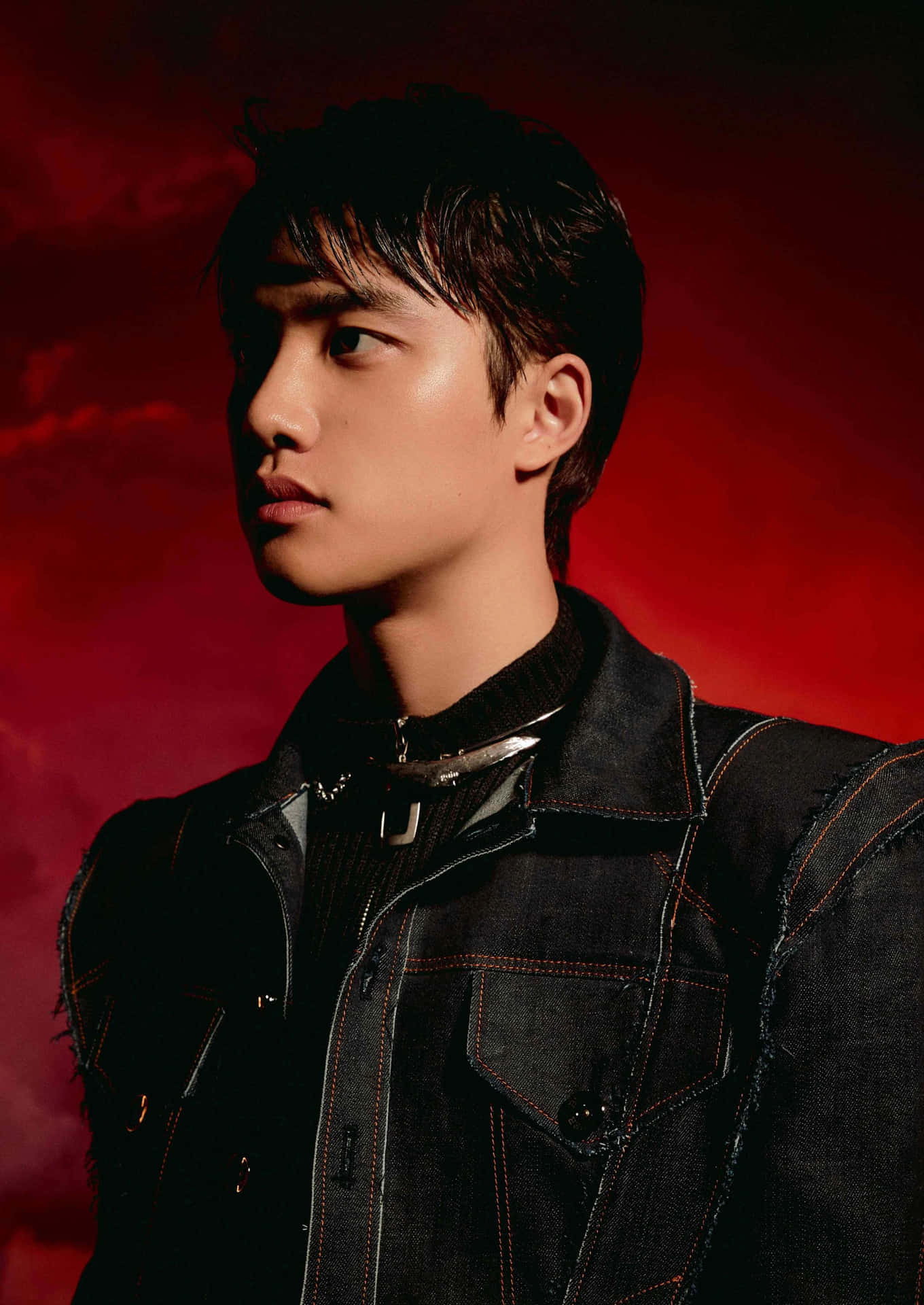 EXO 登台演出 — 音樂的力量 壁紙 — 一位身穿深色牛仔外套的年輕男子，在戲劇性的紅色紋理背景前若有所思地凝視。