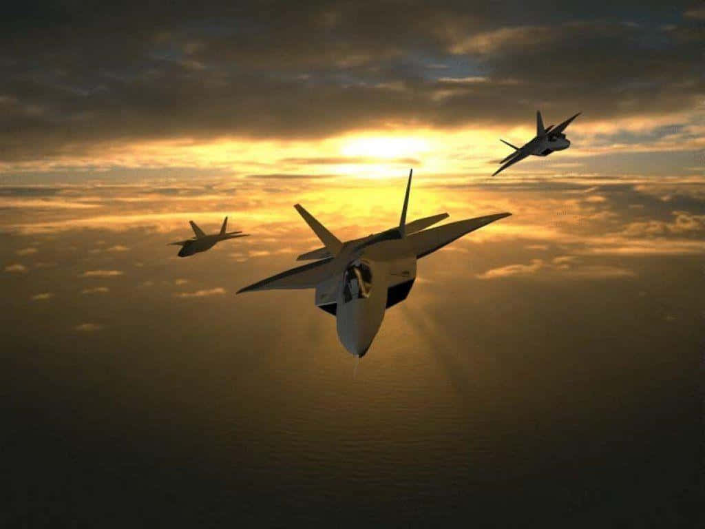 三架戰鬥機在日落時分在海洋上空編隊飛行。