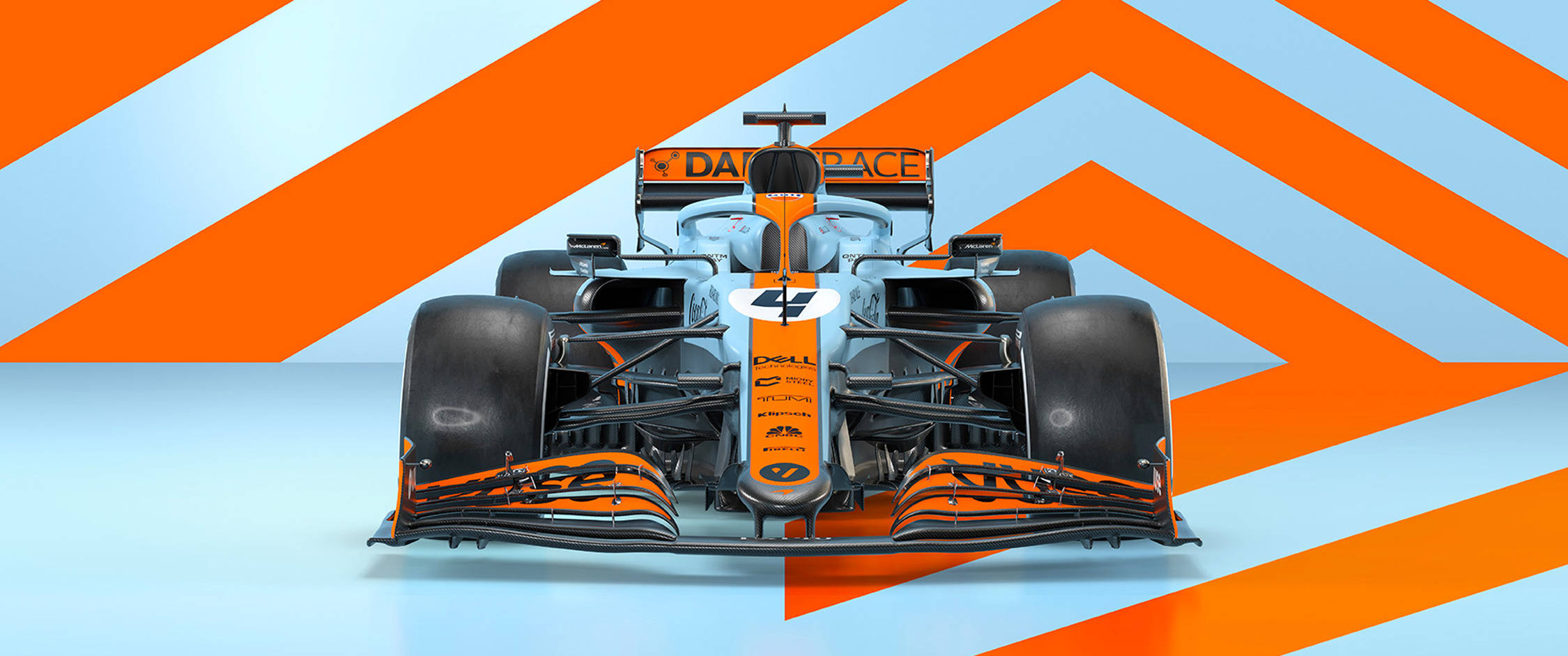 F1賽車橙白風格桌面壁紙 壁紙 — 一輛編號47的麥拿倫一級方程式賽車，以鮮明的橙色和淺藍色V形圖案背景為中心。