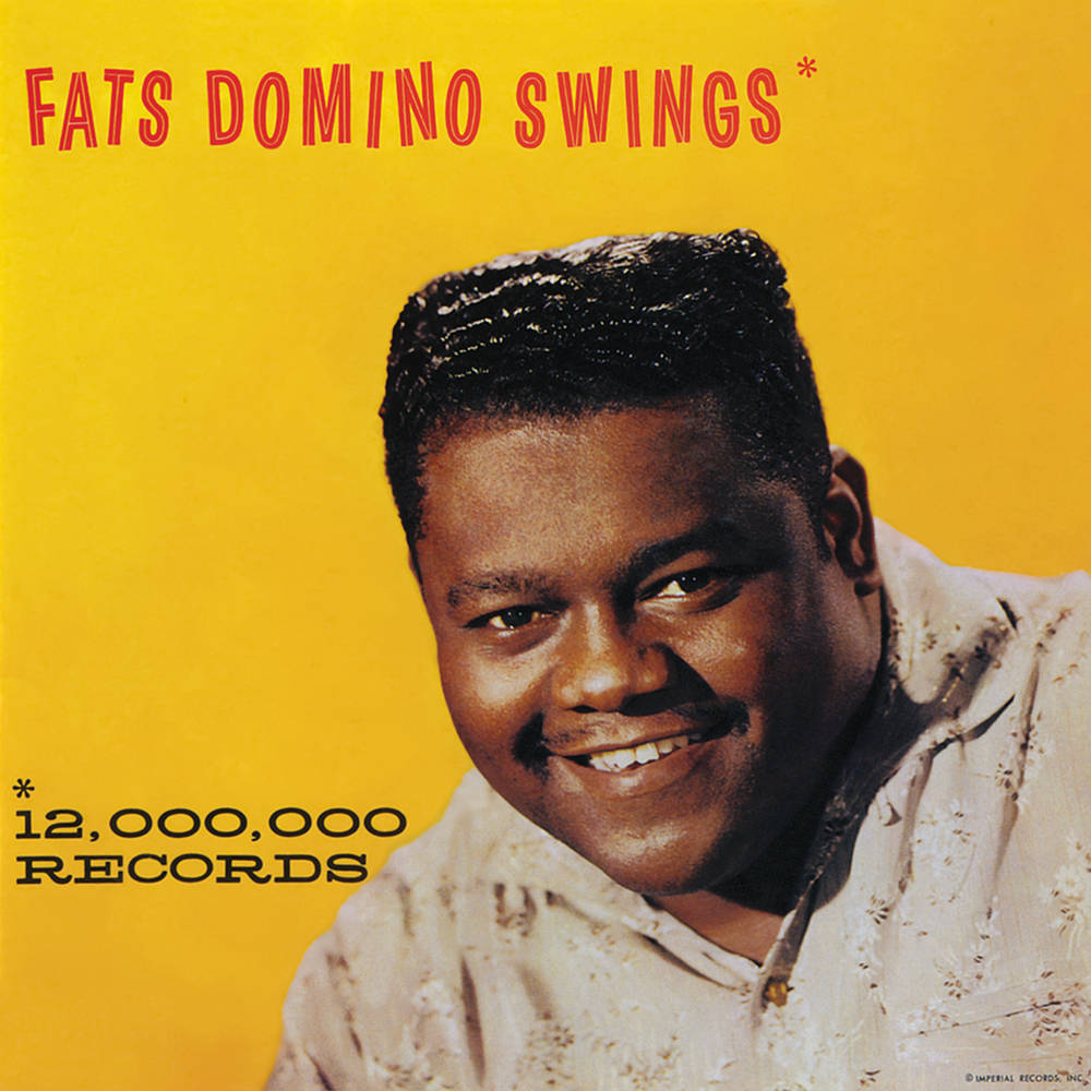 Fats Domino搖滾廣告 壁紙 — Fats Domino 在鮮黃色背景上溫暖微笑，這是他的《Swings》專輯封面。
