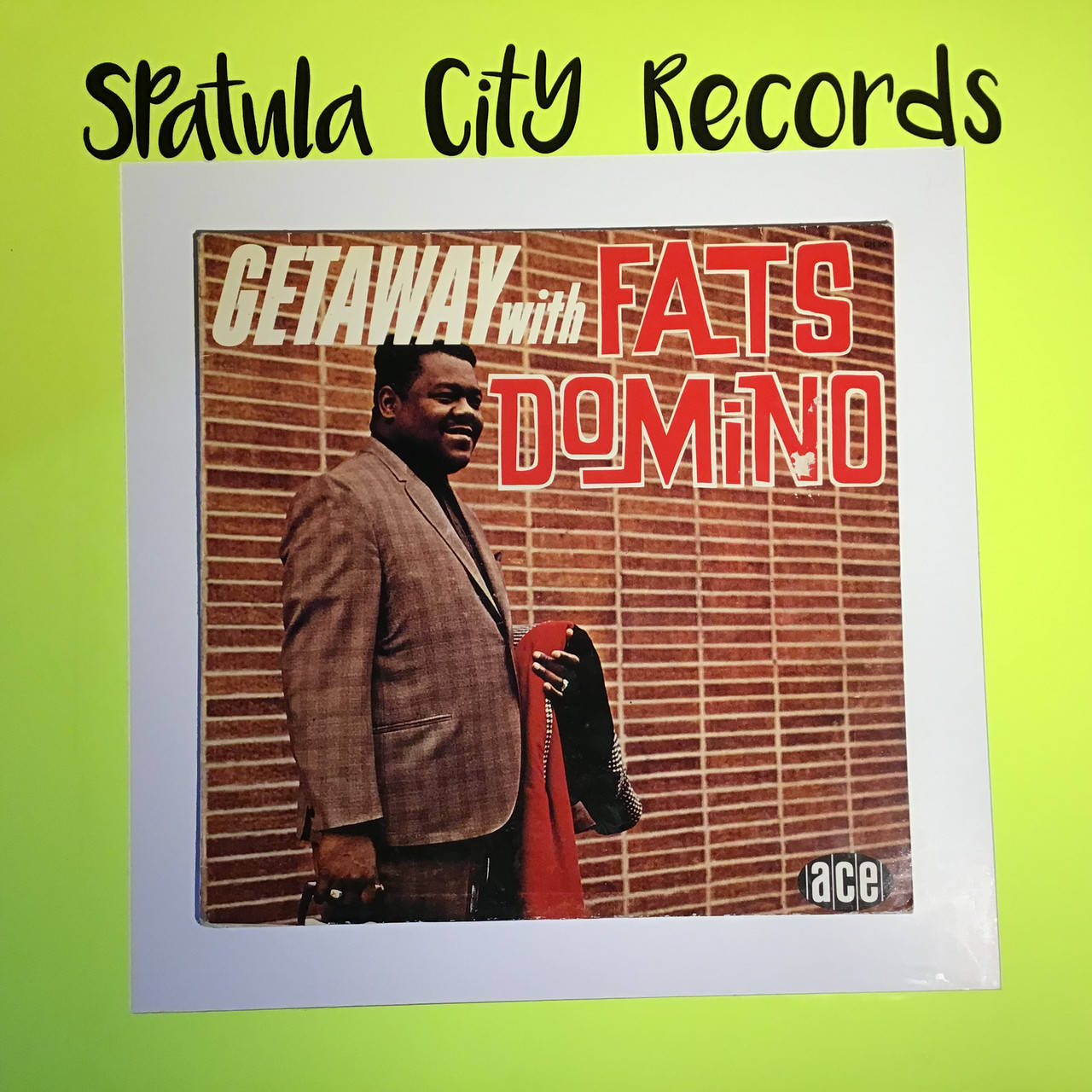 Fats Domino R & B專輯封面 壁紙 — Fats Domino 嘅復古專輯封面，佢對住磚牆微笑，裱起咗並展示喺明亮嘅青檸綠色背景上。