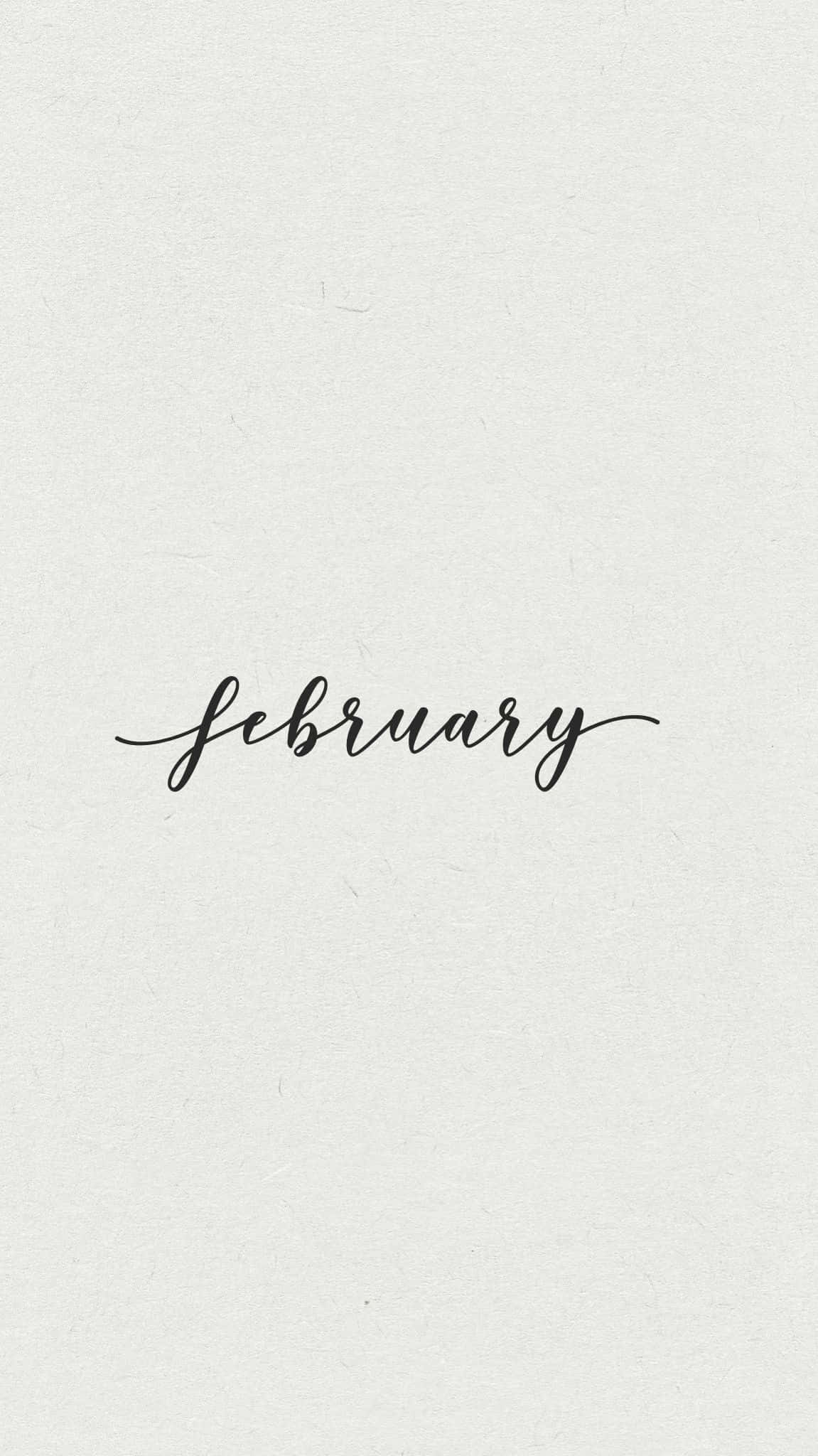 二月 桌布 壁紙 — 「February」一詞以優雅的黑色草書字體居中印在帶紋理的米白色紙上。