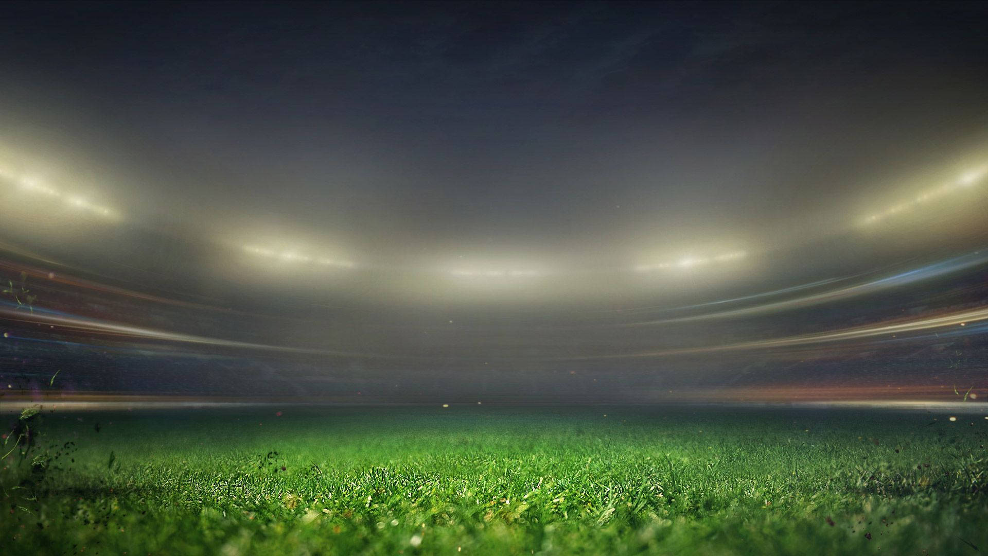 夜晚明亮燈光下的足球場，帶有運動模糊軌跡。 — 運動 壁紙