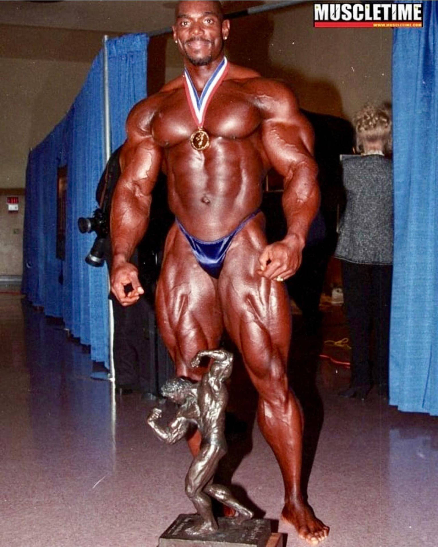 健美運動員在比賽獲勝後手持獎盃和獎牌