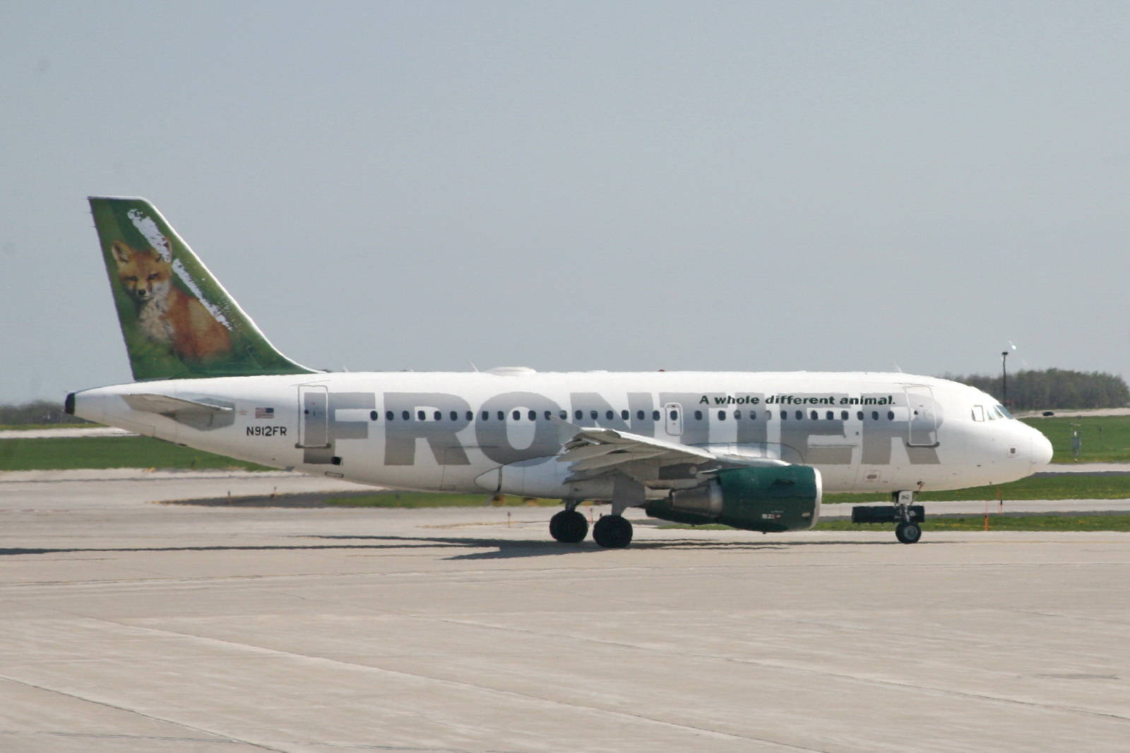 邊疆航空狐狸尾翼設計的飛機停在停機坪上。