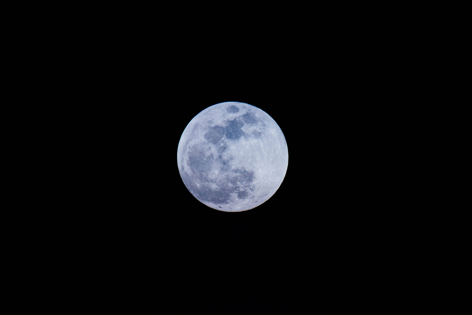 滿月在午夜的天空中明亮地閃耀。月球表面的環形山清晰可見。