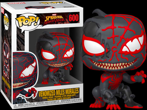 毒液化米爾斯·莫拉萊斯 Funko Pop 公仔 壁紙 — 一個黑色和紅色的毒液化邁爾斯·莫拉萊斯 Funko Pop! 人偶，帶有發光的白色眼睛和鋒利的牙齒，展示在其收藏盒旁邊。