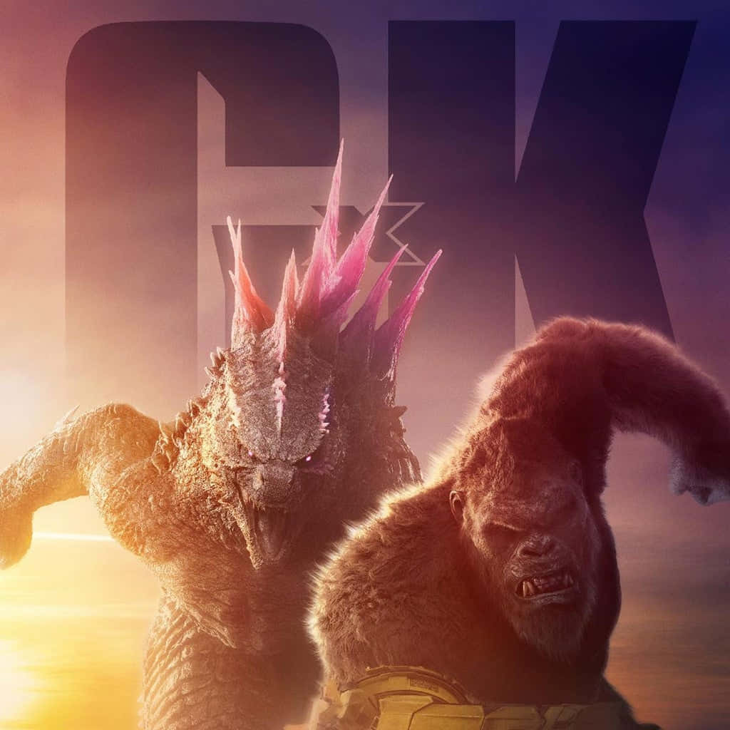 Godzilla X Kong The New Empire 桌布 壁紙 — 哥斯拉與金剛在戲劇性的日落戰鬥中碰撞，發光的背鰭和巨大的剪影映襯著火熱的天空。