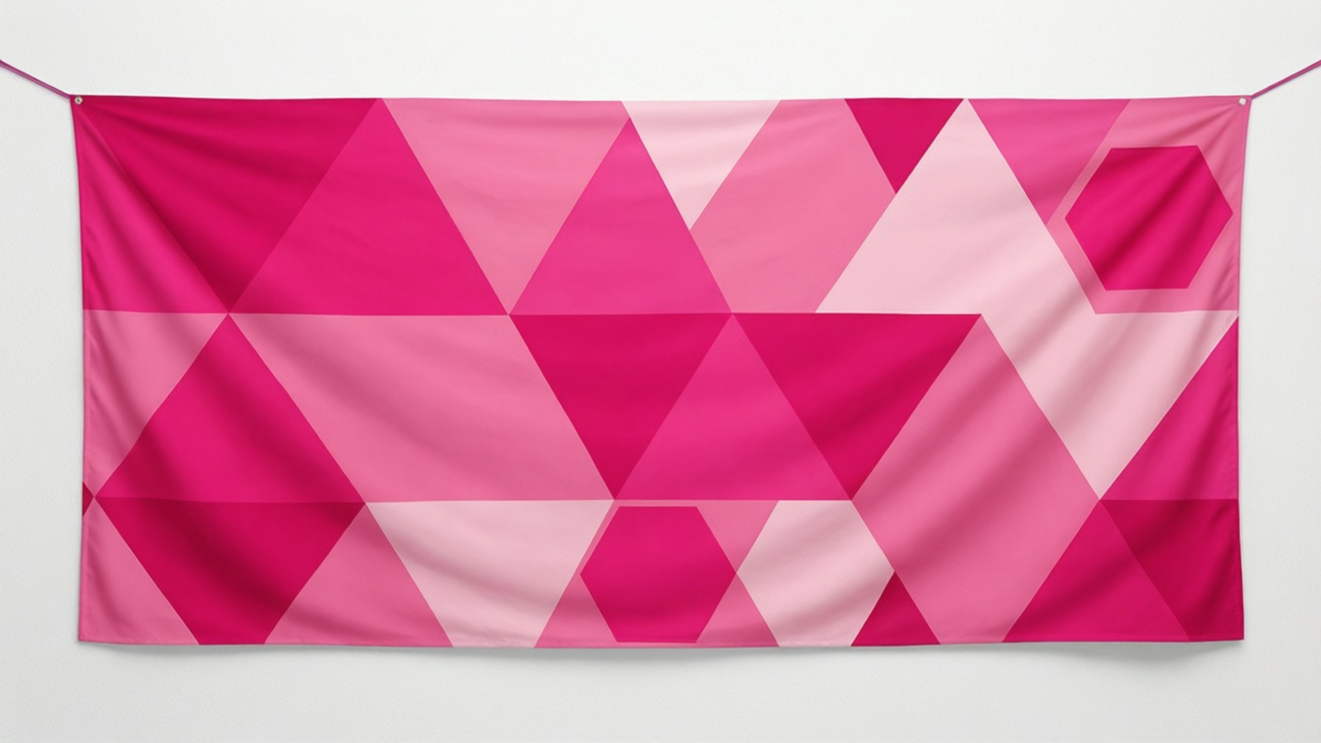 Geometric Pink Banner Pattern 壁紙 — 一面充滿活力的粉紅色幾何旗幟，帶有三角形和六邊形，掛在純白色的牆上。