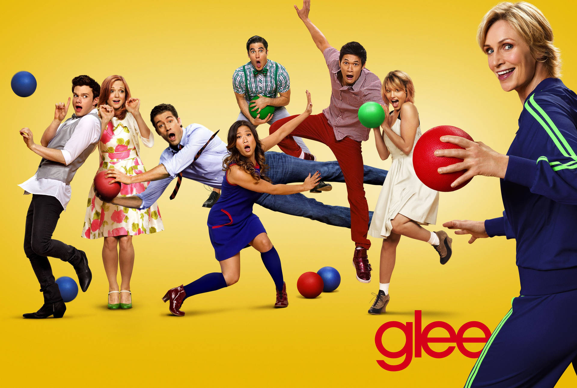 Glee 演員在黃色背景下充滿活力地投擲躲避球。