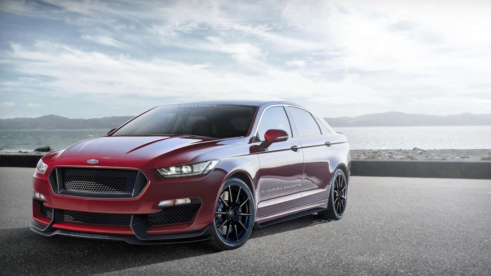 Ford Taurus 桌布 壁紙 — 一架光澤紅色高性能房車配黑色輪圈，停泊在俯瞰平靜大海的海岸公路上，天空多雲。