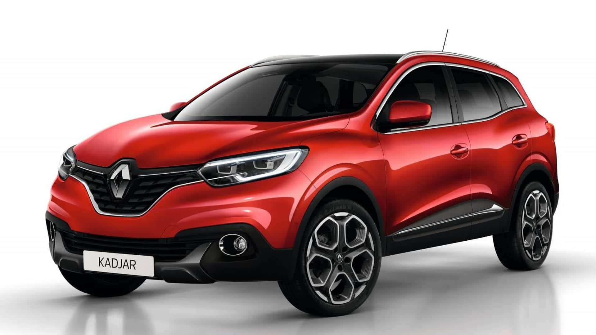  壁紙 — 一輛亮紅色雷諾 Kadjar SUV 在攝影棚燈光下展示，配備黑色飾邊和時尚合金輪圈。