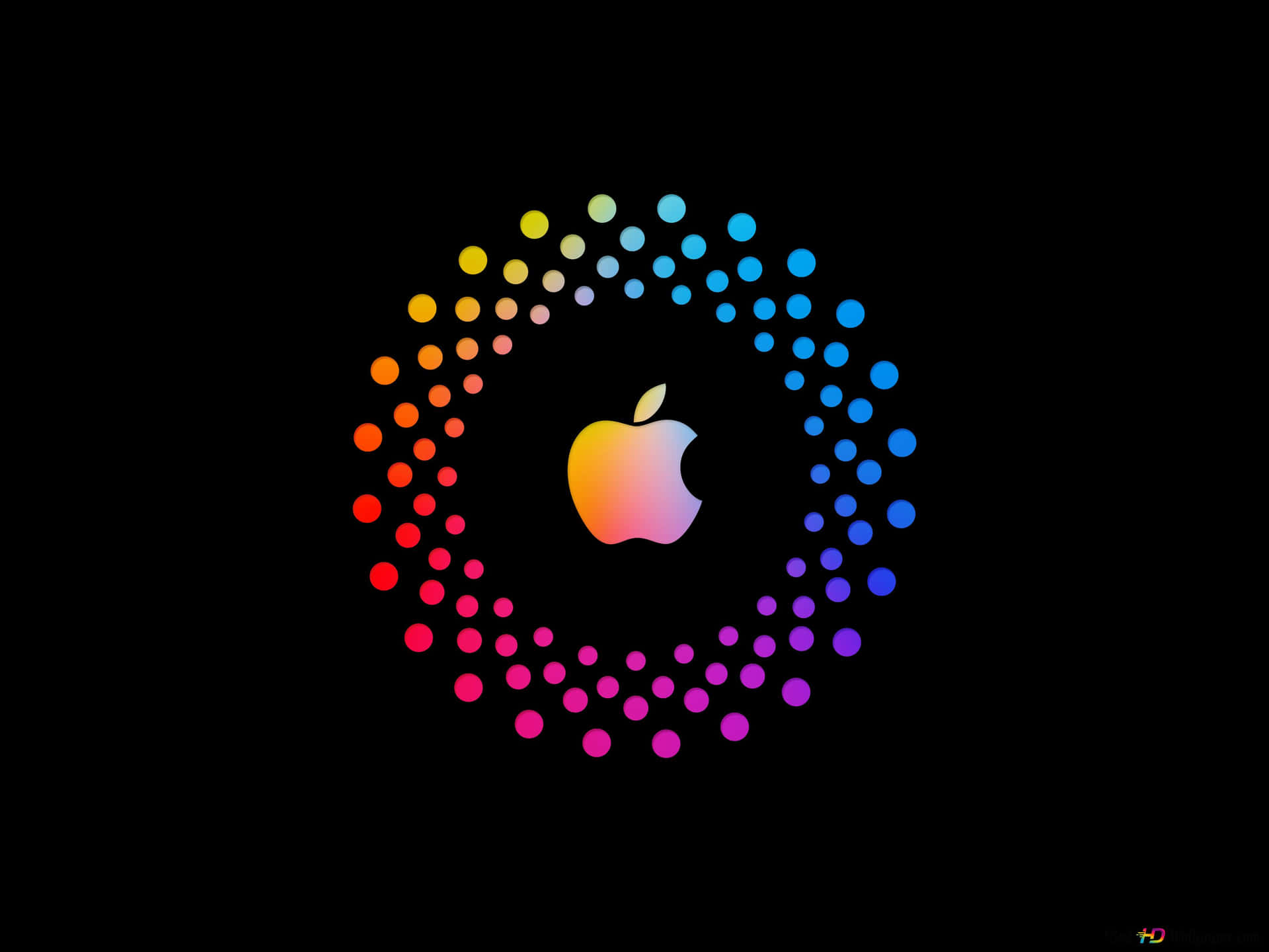 自然靈感 Apple | 欣賞果園之美 壁紙 — 一個發光的Apple標誌，被鮮豔的彩虹點環圍繞，背景為黑色。