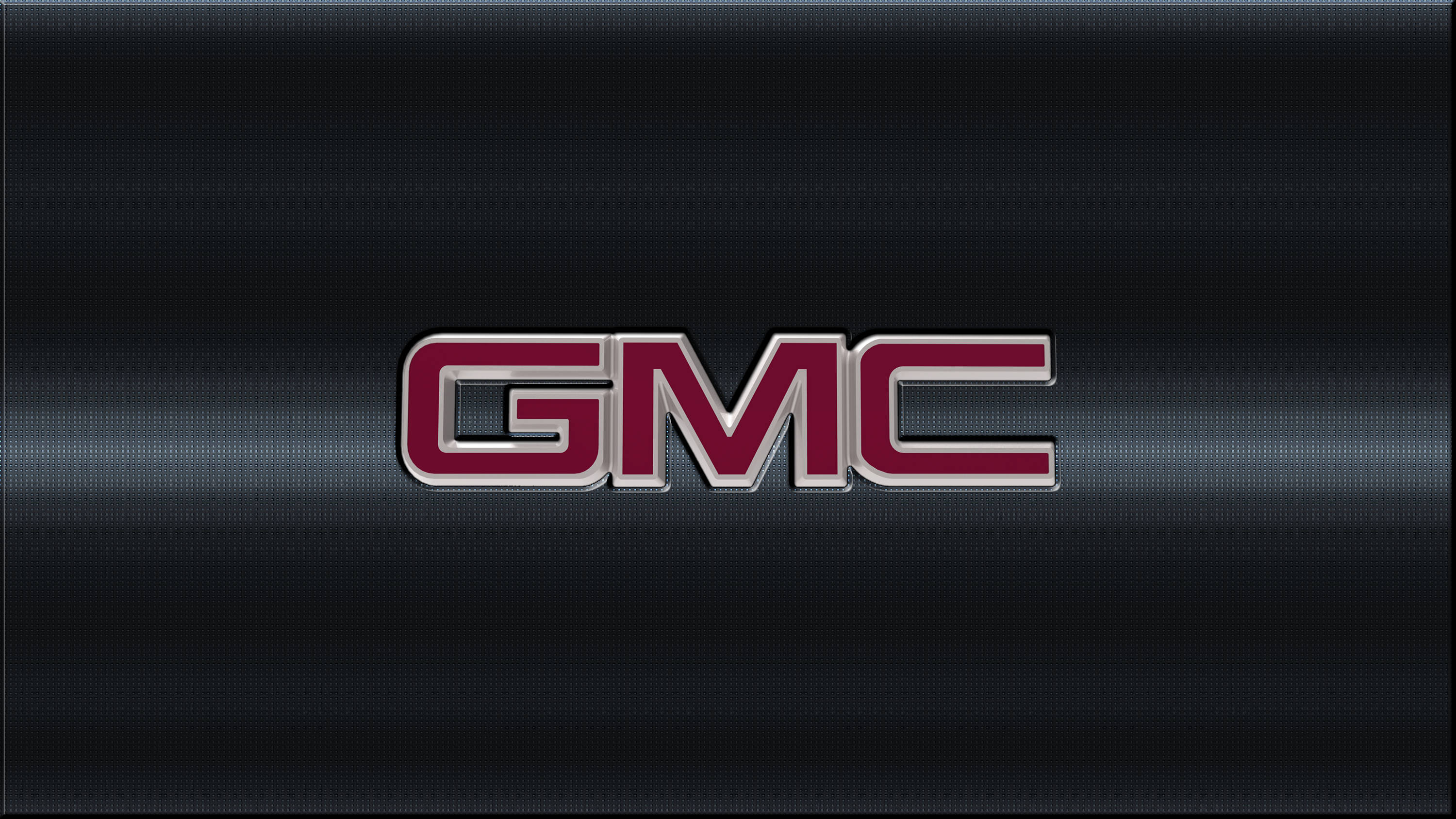 GMC公司標誌於抽象背景 壁紙 — GMC 標誌以粗體紅色和銀色字母居中顯示在深色紋理金屬背景上。