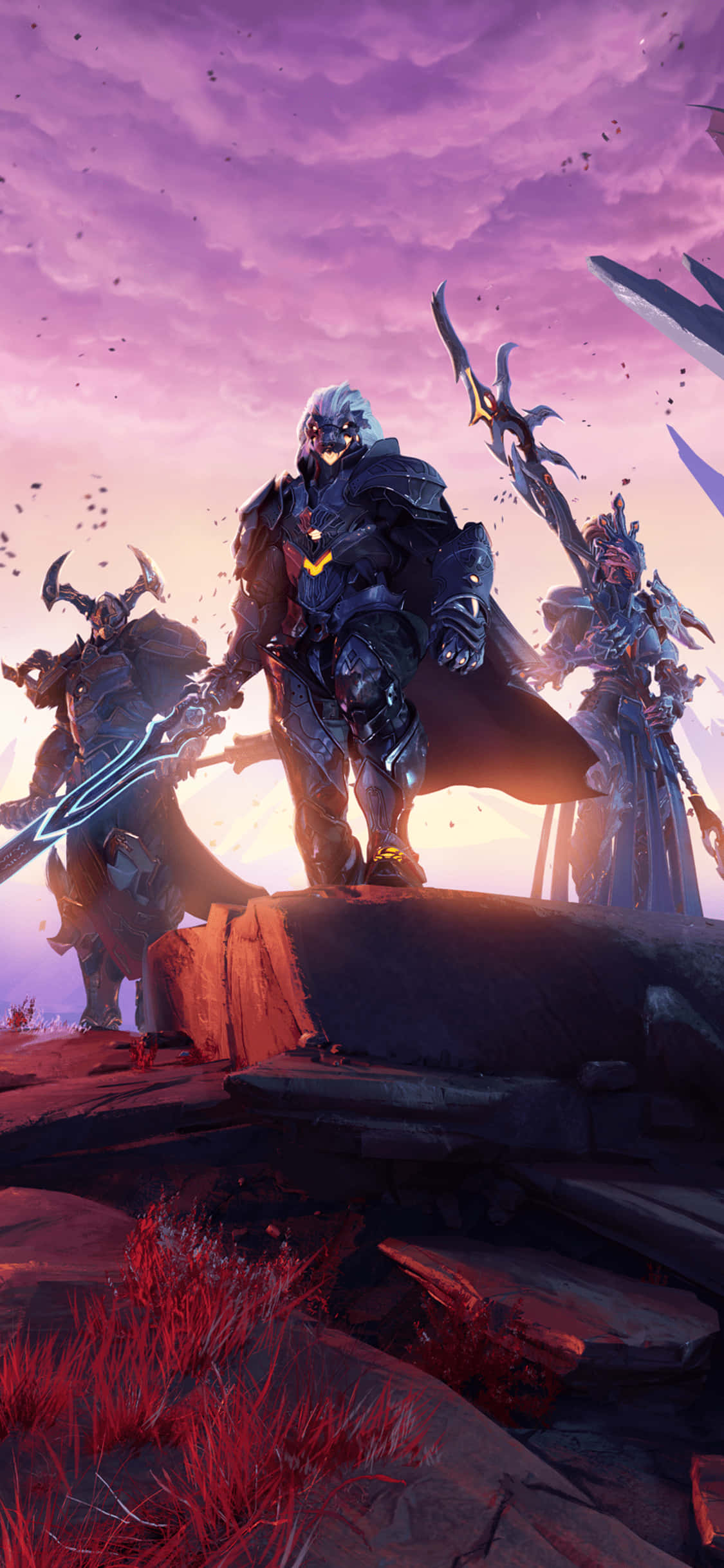 《Godfall》遊戲 iPhone X 背景：三名戰士雲霞日落 壁紙 — 三名身穿鎧甲、手持發光武器的戰士，站在岩石露頭上，背景是充滿活力的紫色日落天空。