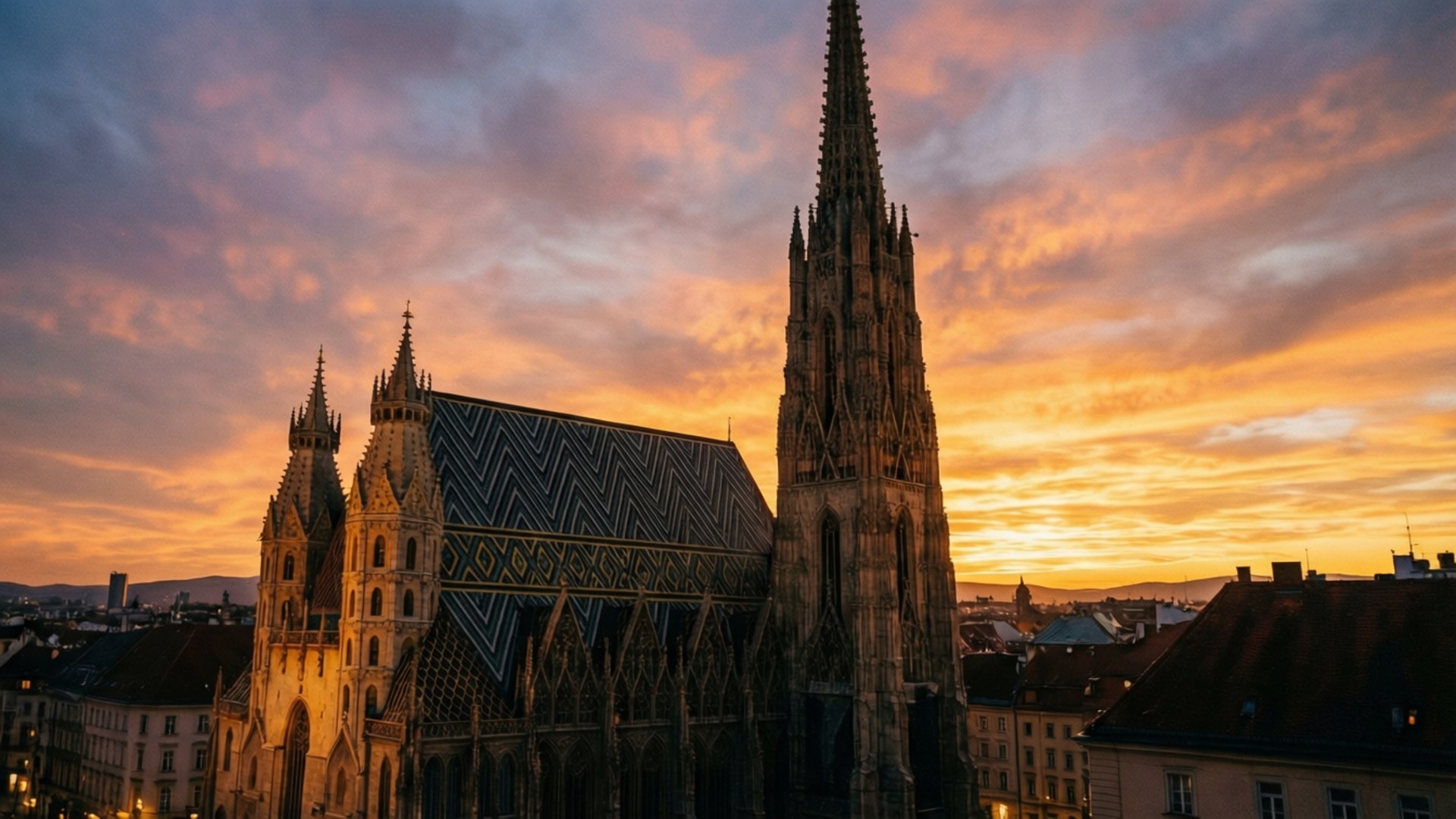 Gothic cathedral at sunset with vibrant orange and purple sky 壁紙