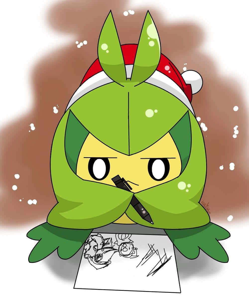 戴聖誕帽的綠色Q版角色在雪中畫畫。