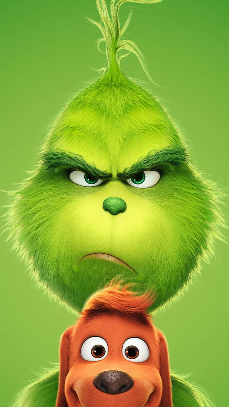  壁紙 — Grinch 憤怒的表情和他的狗 Max 睜大眼睛向上望，背景為純綠色。