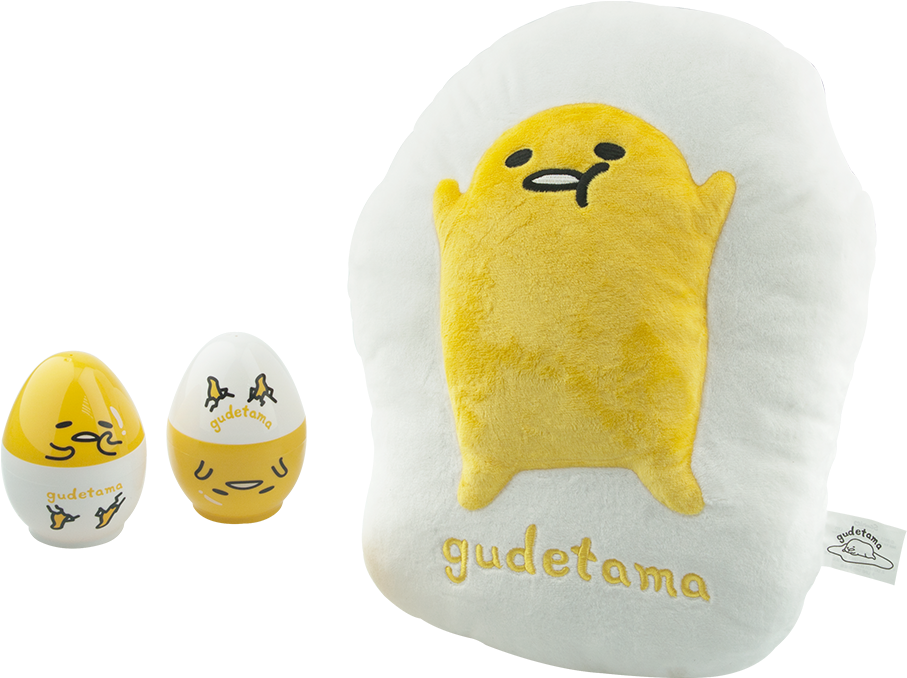 Gudetama 懶蛋玩偶與靠墊 壁紙 — 一個柔軟嘅Gudetama枕頭，形狀似煎蛋，旁邊有兩個細小嘅蛋形公仔，背景係黑色。