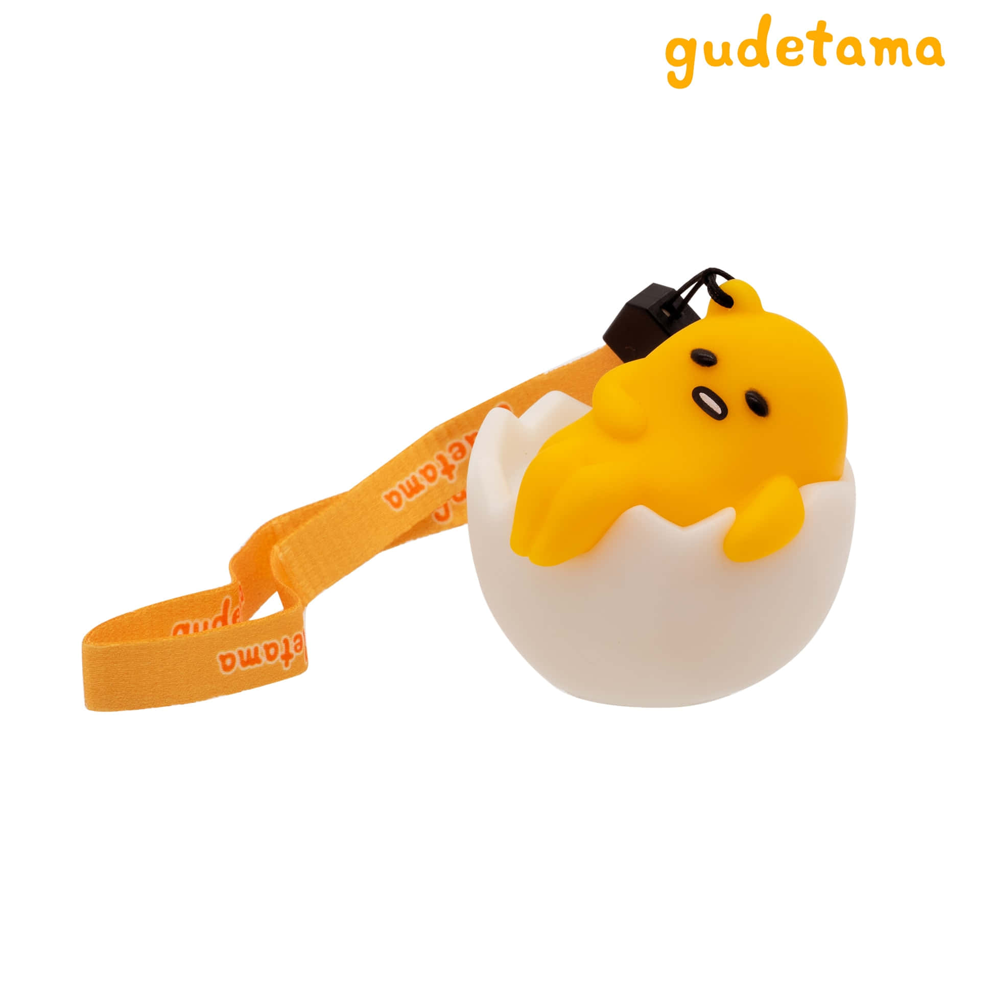 Gudetama毛公仔鎖匙扣喺蛋殼入面攤唞，配橙色帶。