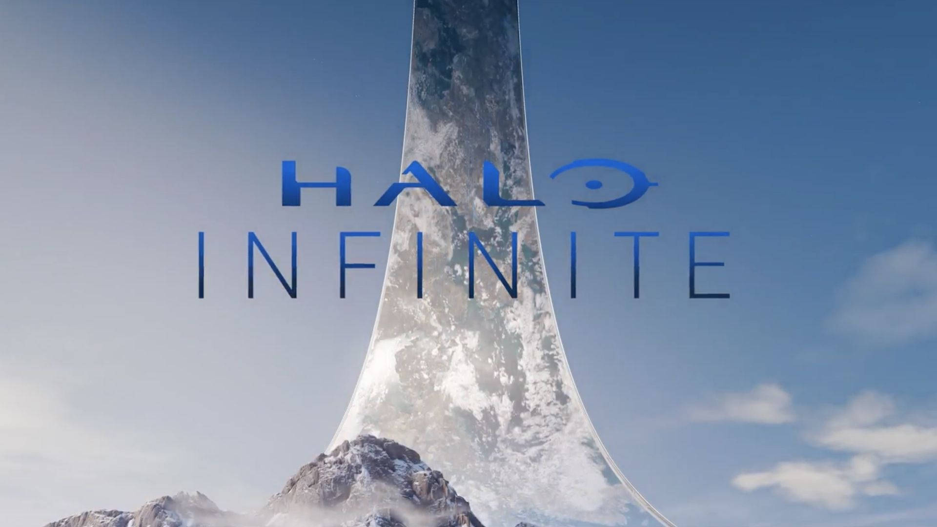 Halo Infinite 標誌在從雪山中出現的發光環上方。