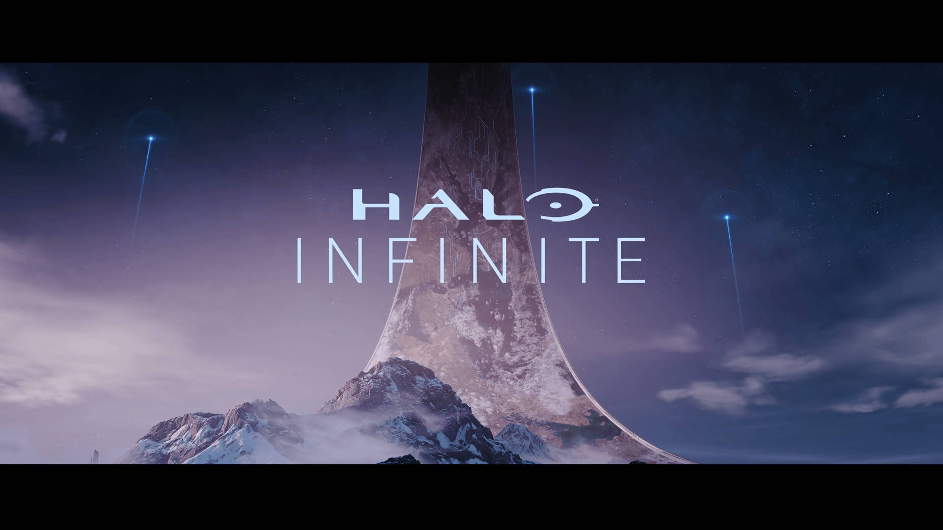 Halo Infinite 標題畫面，在星空下雪山中的巨大獨石。