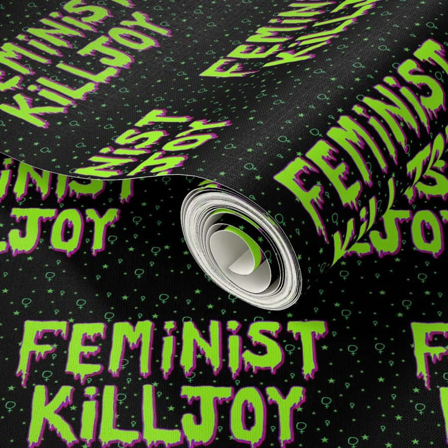  壁紙 — 一卷黑色牆紙，帶有霓虹綠色滴落文字，寫著 feminist killjoy 和女性符號。