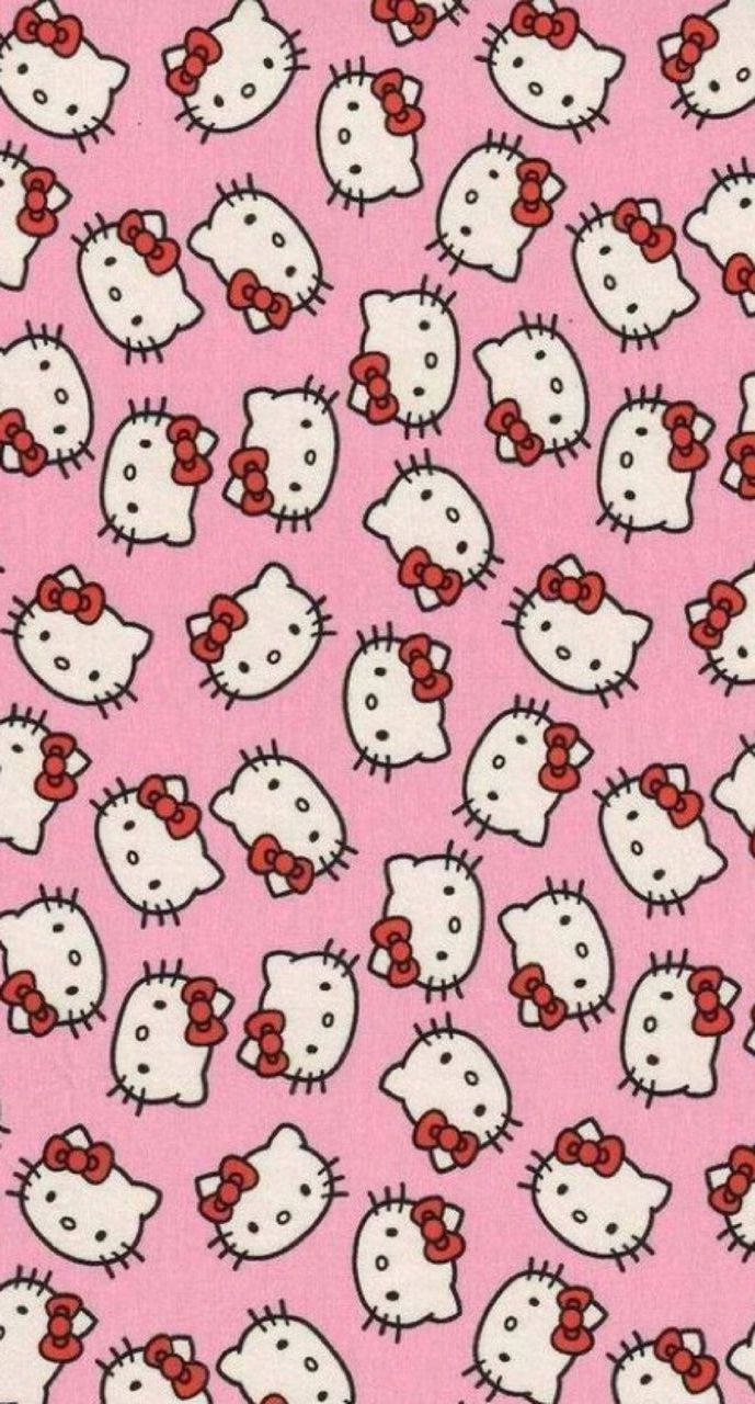 帶有重複Hello Kitty面孔和紅色蝴蝶結的粉紅色牆紙。 — Y2k GIF 壁紙