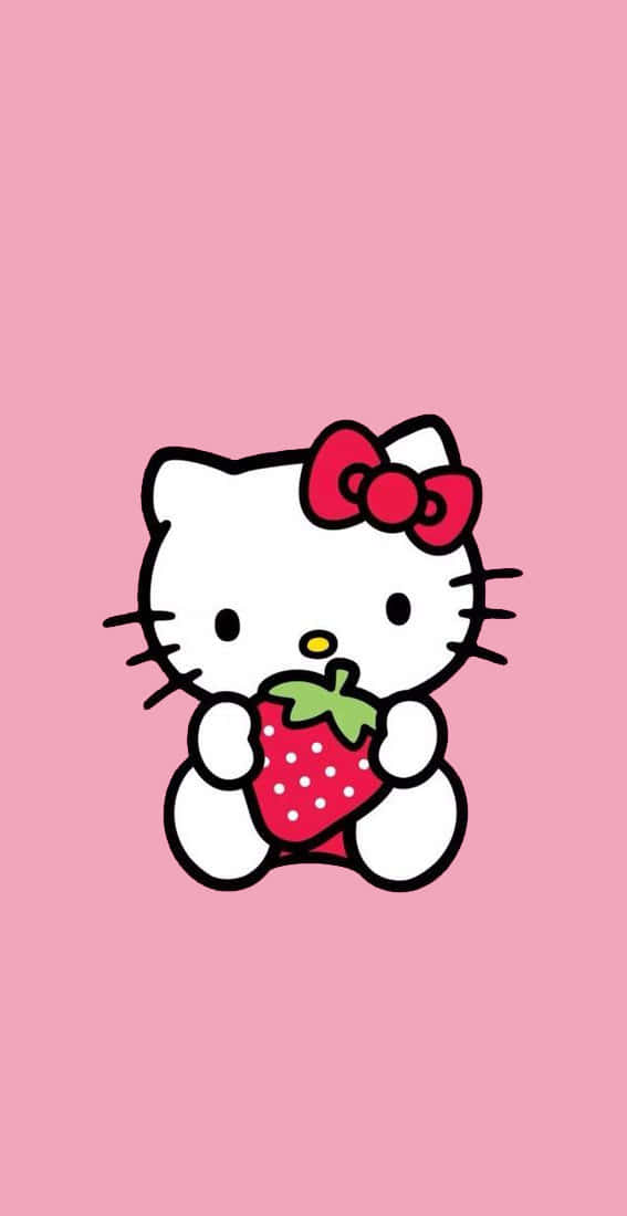 Kawaii Hello Kitty 桌布 壁紙 — Hello Kitty 卡通角色在純粉紅色背景上拿著草莓。