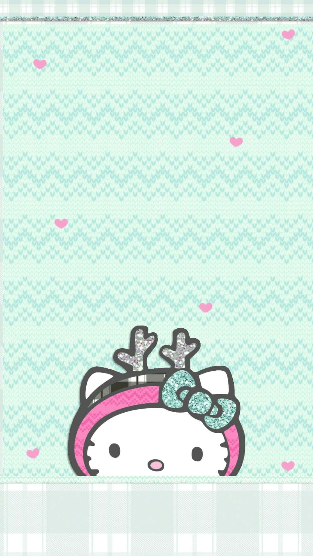 Hello Kitty Christmas 桌布 壁紙 — Hello Kitty 從薄荷綠色針織圖案下方探出頭來，圖案帶有粉紅色心形和閃閃發光的鹿角。