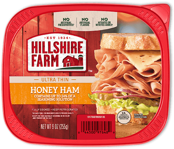 Hillshire Farm蜂蜜火腿包裝 壁紙 — Hillshire Farm 蜂蜜火腿三文治的特寫，放在紅色塑膠容器中，背景為鄉村風格木紋。