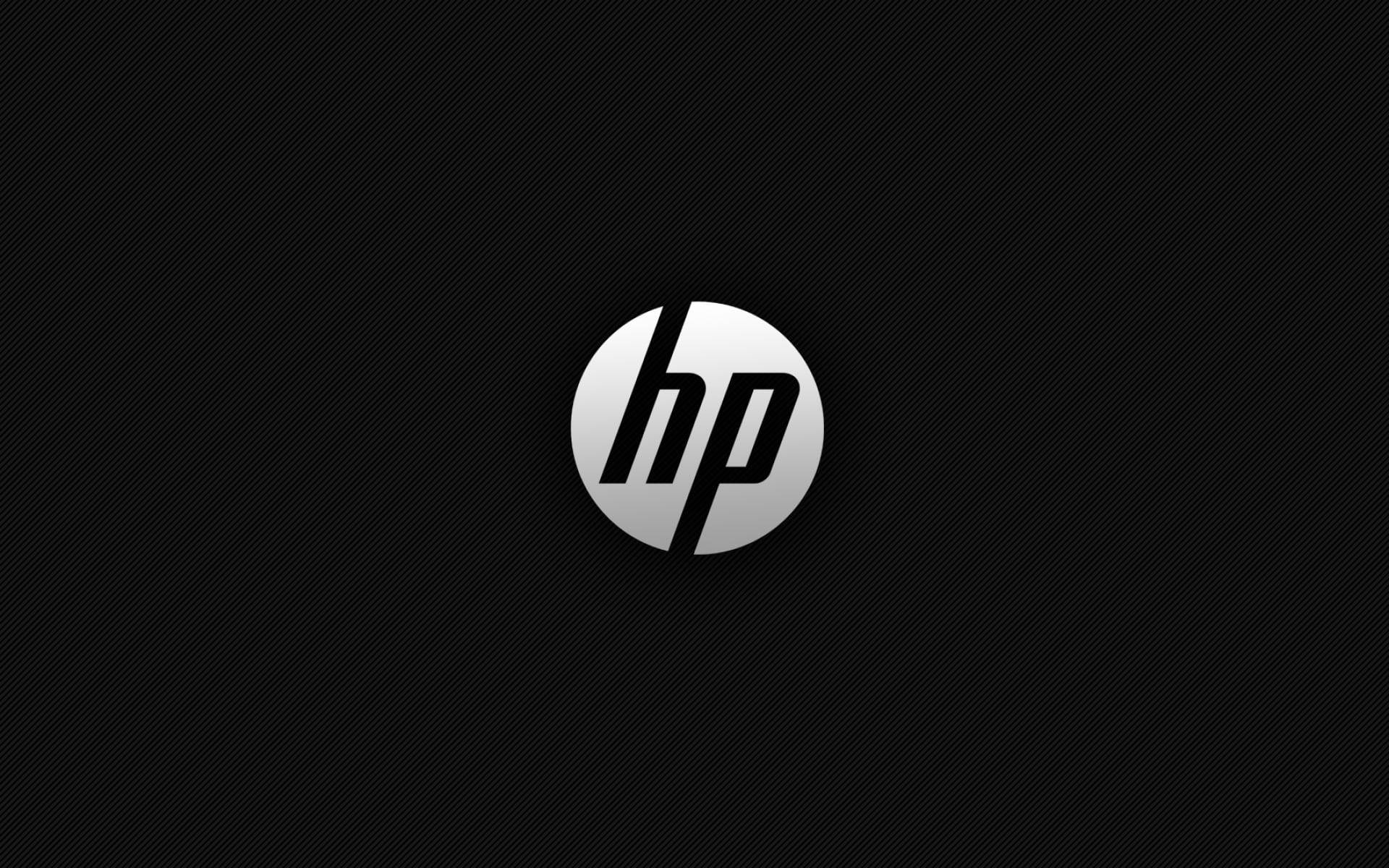 Simple White Round HP Laptop Logo 壁紙 — HP 標誌居中於黑色碳纖維紋理背景上，帶有金屬銀色漸變效果。