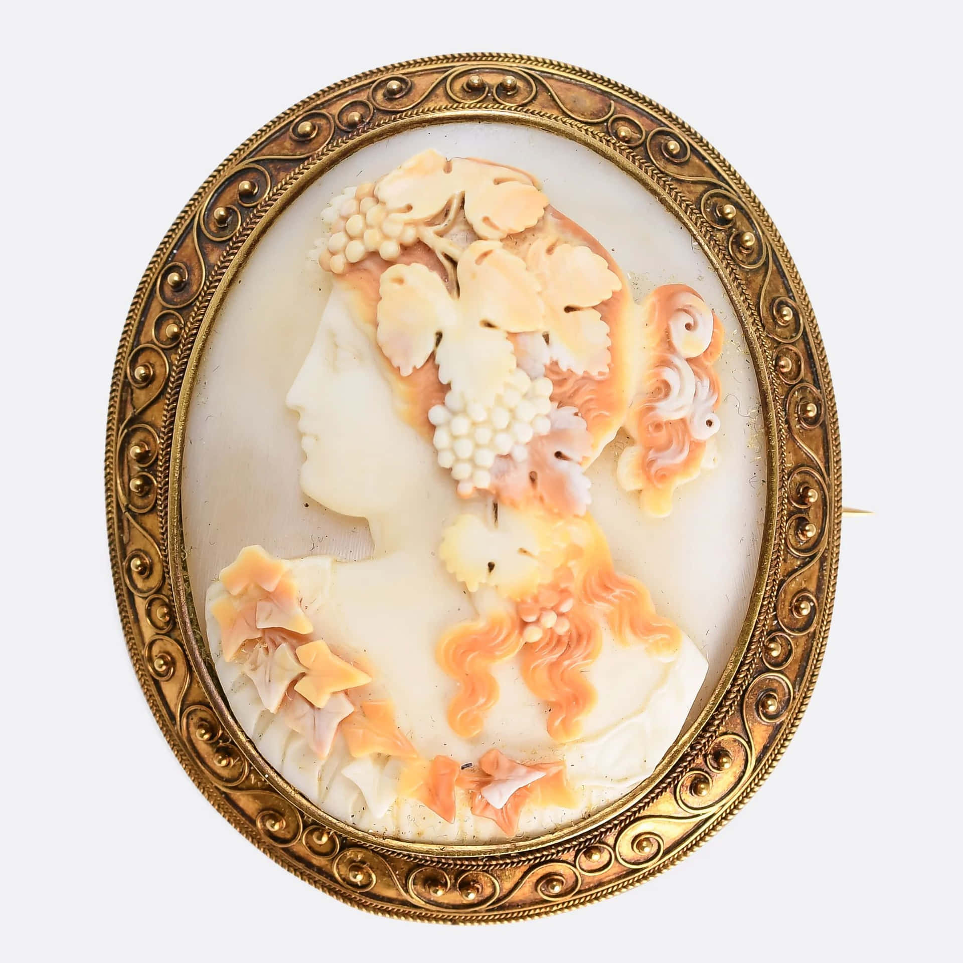  壁紙 — 一個華麗的金框浮雕胸針，上面雕刻著一位女性的側面輪廓，飾以葡萄藤和葉子，色調柔和，帶有蜜桃色和奶油色。