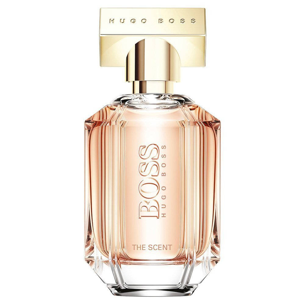Hugo Boss香水瓶，帶有金色蓋和粉紅色液體。