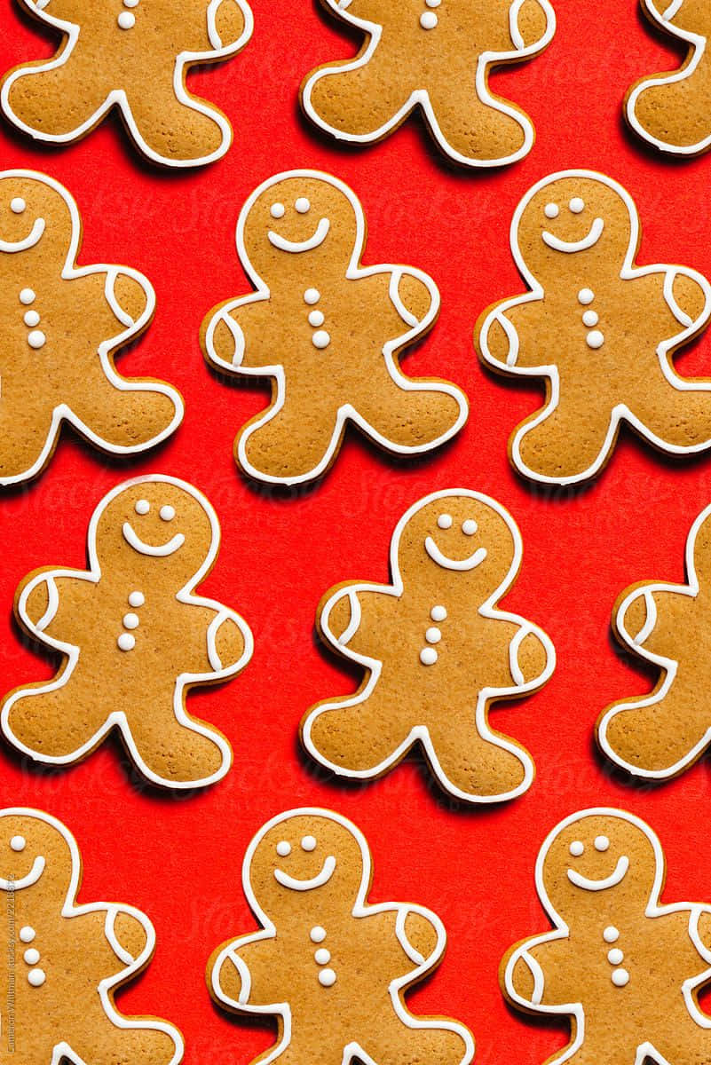 壁紙 — 充滿活力的紅色背景，上面佈滿了微笑的薑餅人曲奇，並以白色糖霜勾勒出輪廓。