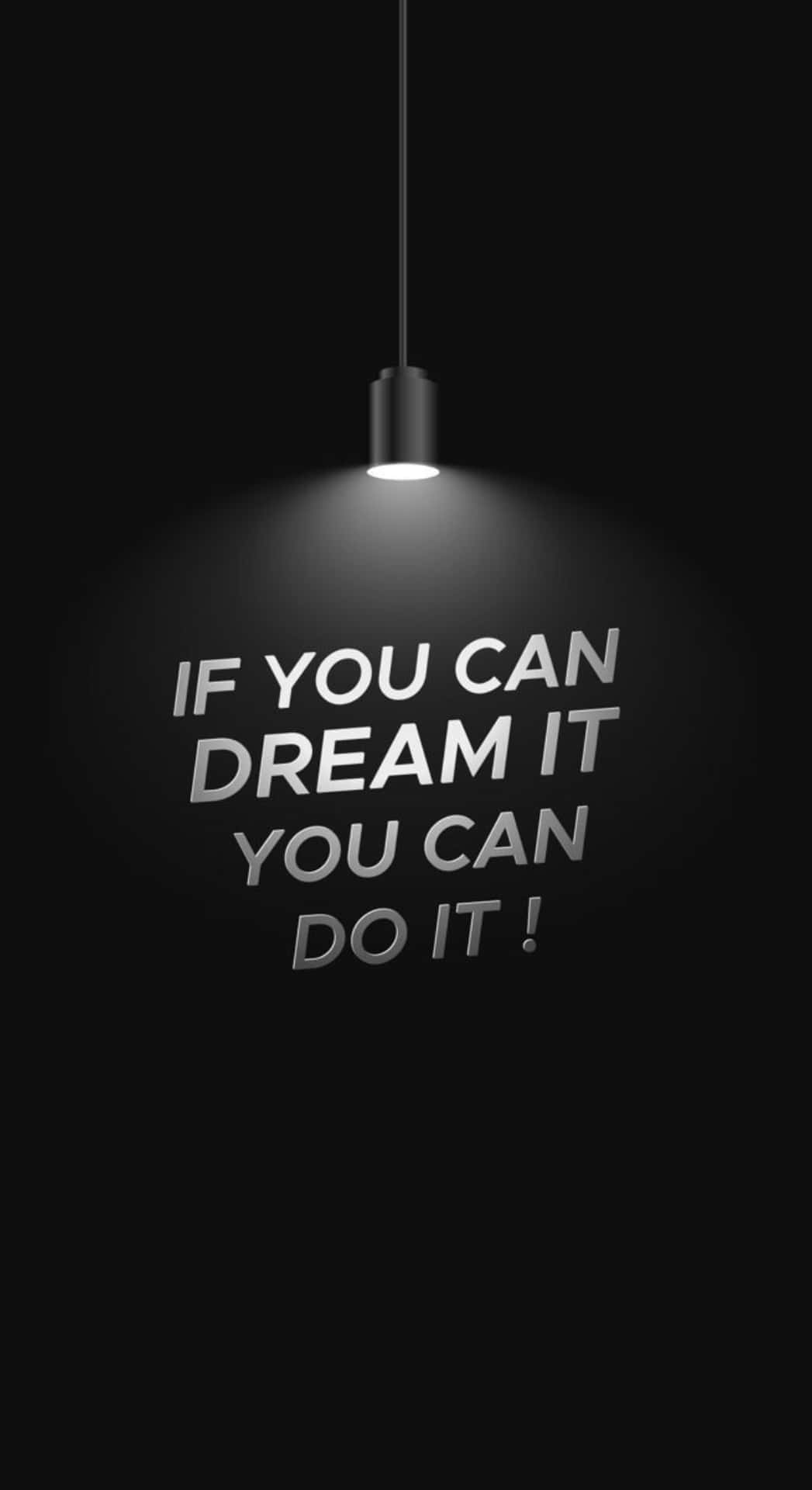  壁紙 — 一個聚光燈照亮了黑色背景上的勵志短語「IF YOU CAN DREAM IT YOU CAN DO IT!」。