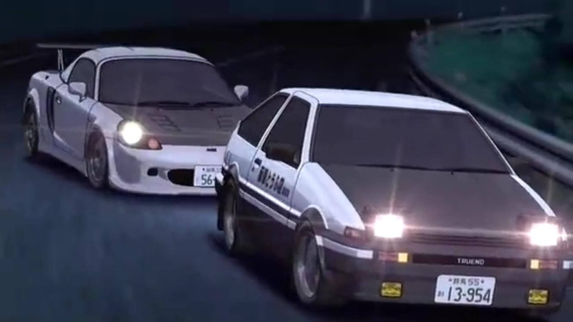 兩輛白色日本飄移車在夜間於潮濕的道路上奔馳。