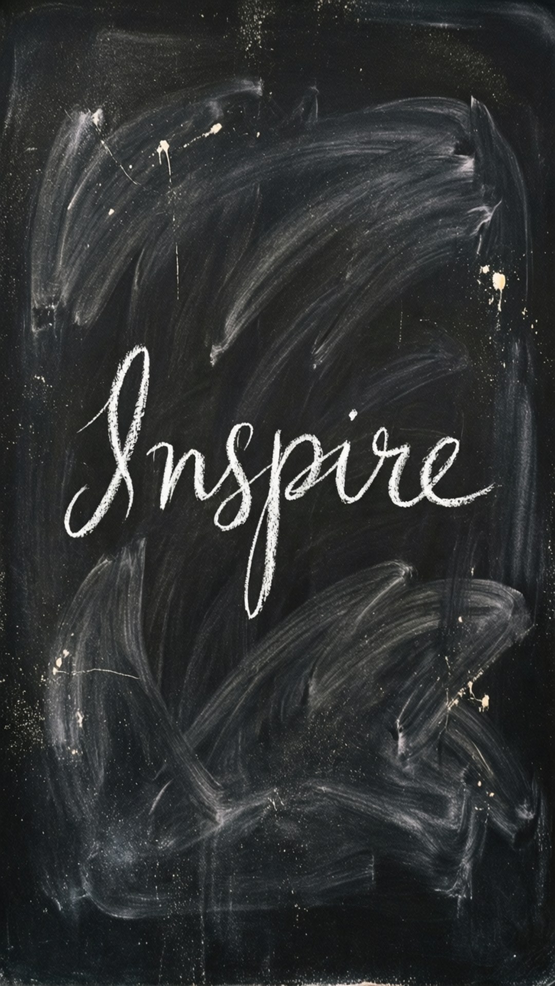 桌布 壁紙 — 「Inspire」一詞以優雅的白色草書寫在帶有紋理的黑色黑板上，並帶有模糊的粉筆筆劃。