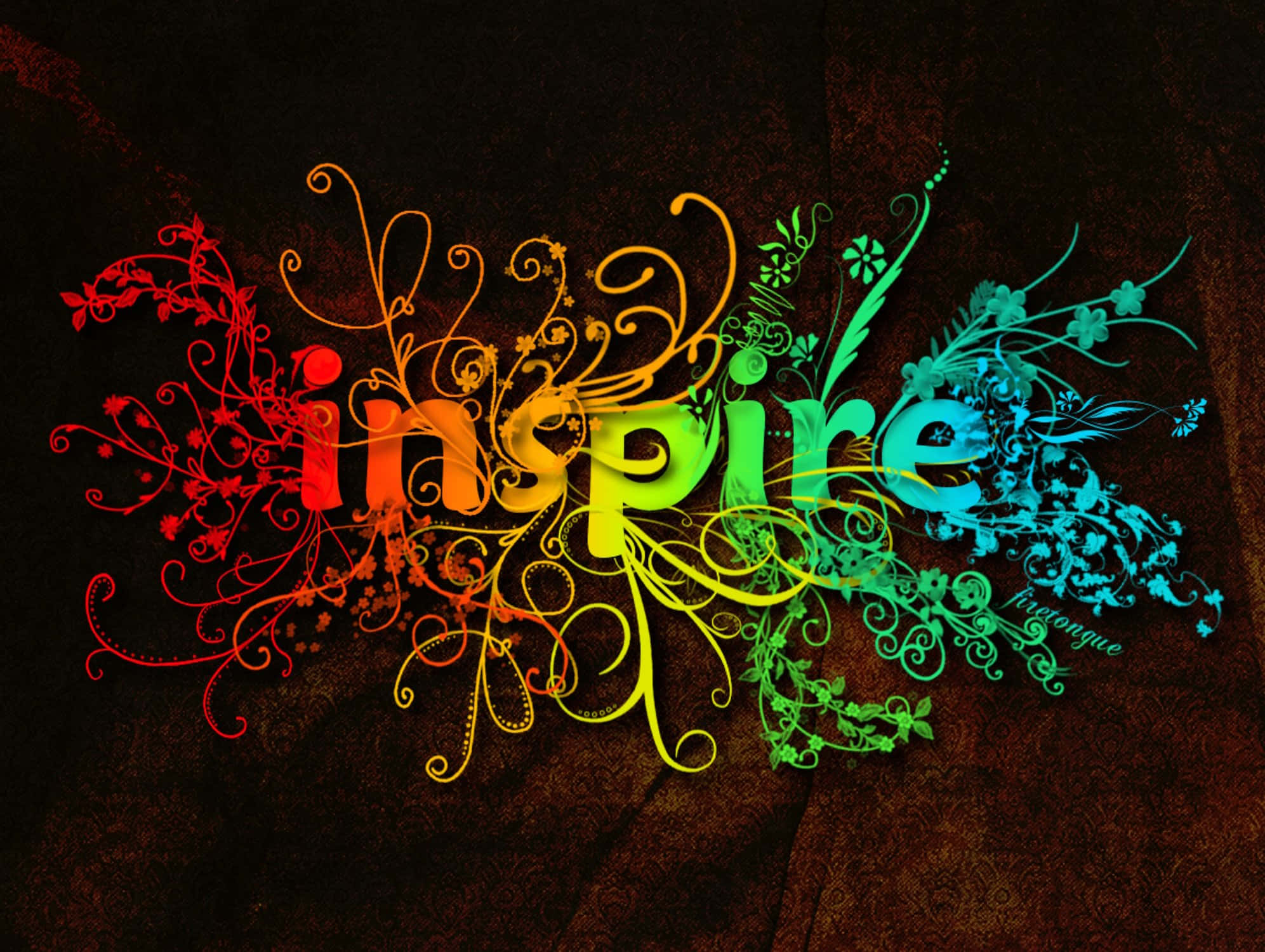 型格 桌布 壁紙 — 「inspire」一詞在深色紋理背景上，被華麗的花卉漩渦環繞，散發出彩虹色光芒。
