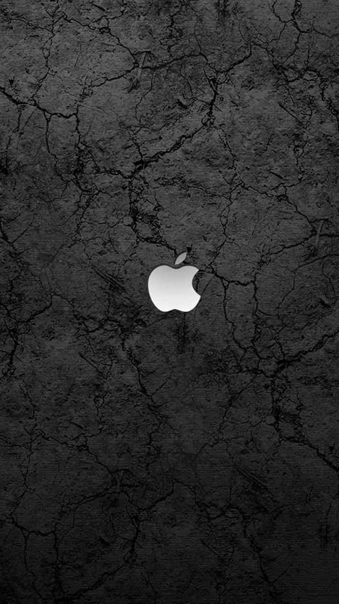白色Apple標誌在裂紋黑色混凝土背景上。