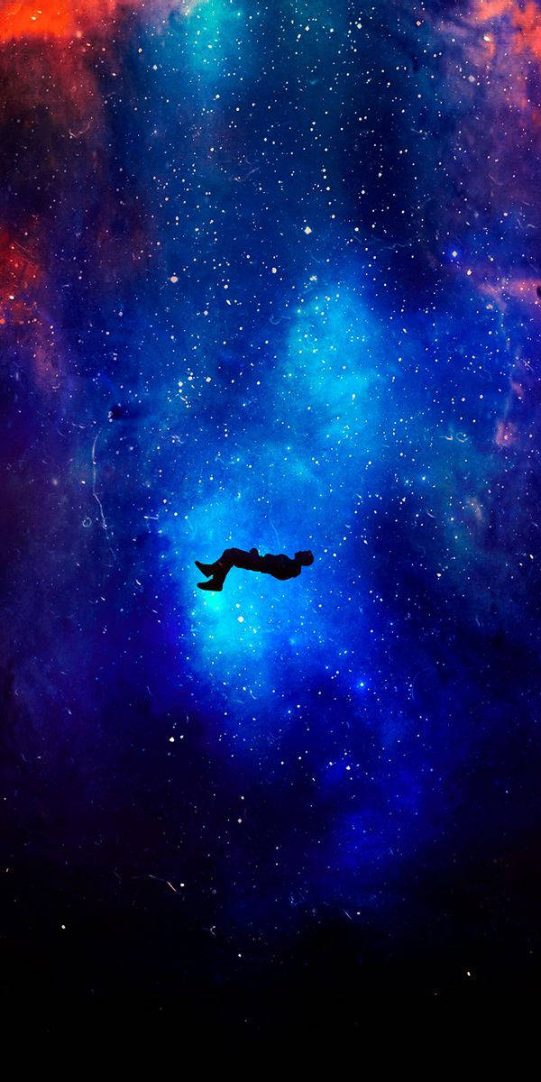 一個人在太空中色彩繽紛的星雲中漂浮。