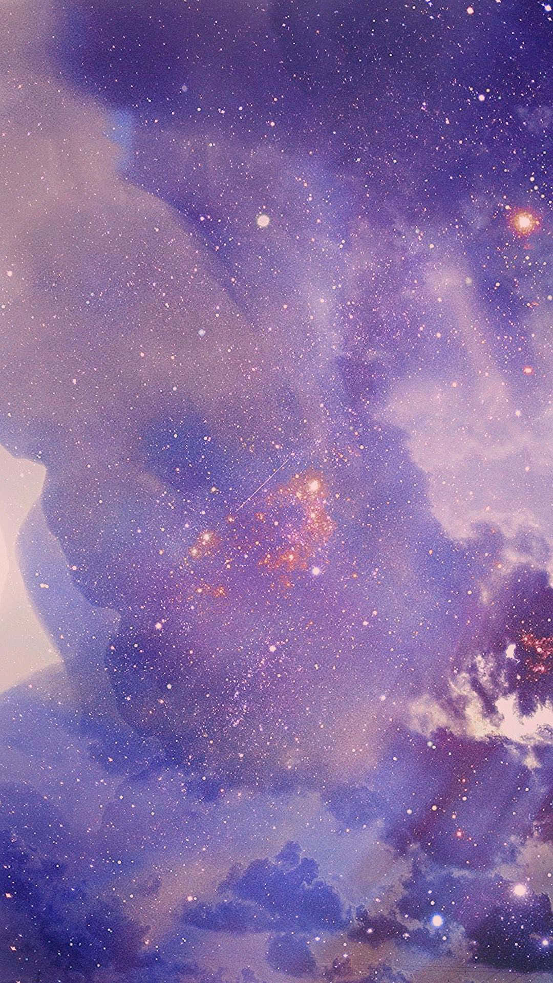 搶先擁有時尚潮流紫色柔霧 iPhone 壁紙 — 夢幻般的宇宙場景，有旋轉的紫色星雲和發光的橙色星星，映襯著柔和的漸變天空。
