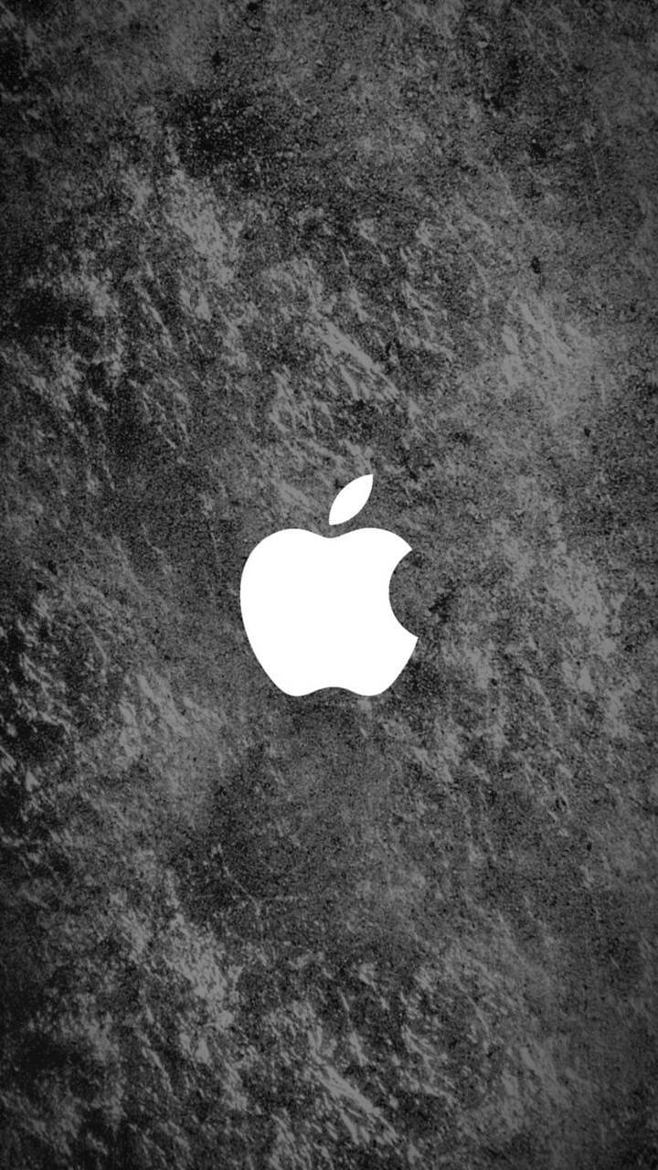 白色Apple標誌在深色有紋理的混凝土背景上。
