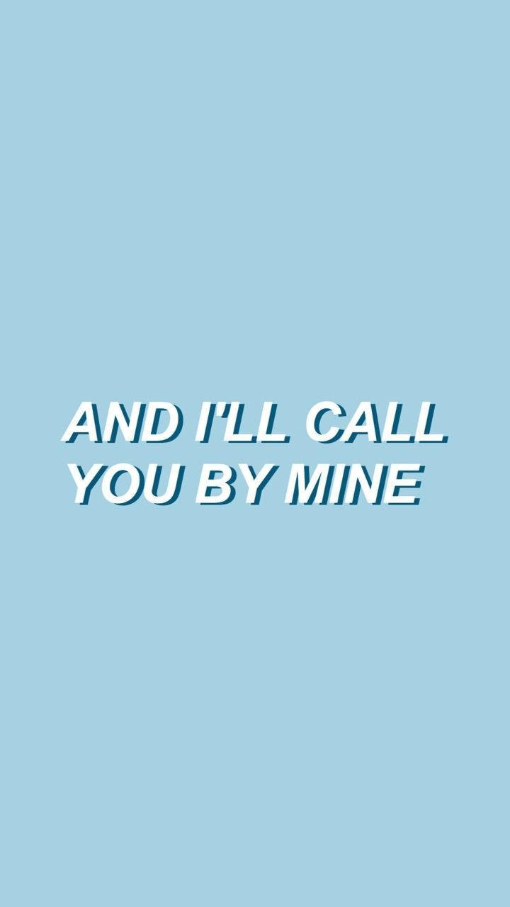 簡約藍色美學語錄 iPhone 壁紙 — 粗體白色文字「AND I'LL CALL YOU BY MINE」居中顯示在純淺藍色背景上。