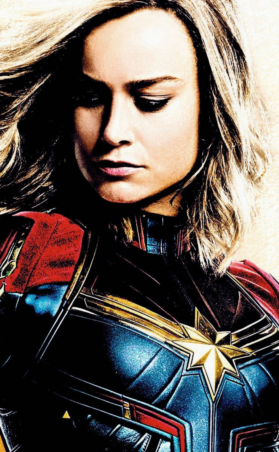 布莉·拉森 飛躍女超人 iPhone 壁紙 — Marvel 隊長身穿標誌性的藍、紅、金色戰衣，神情堅定，金色長髮飄逸。