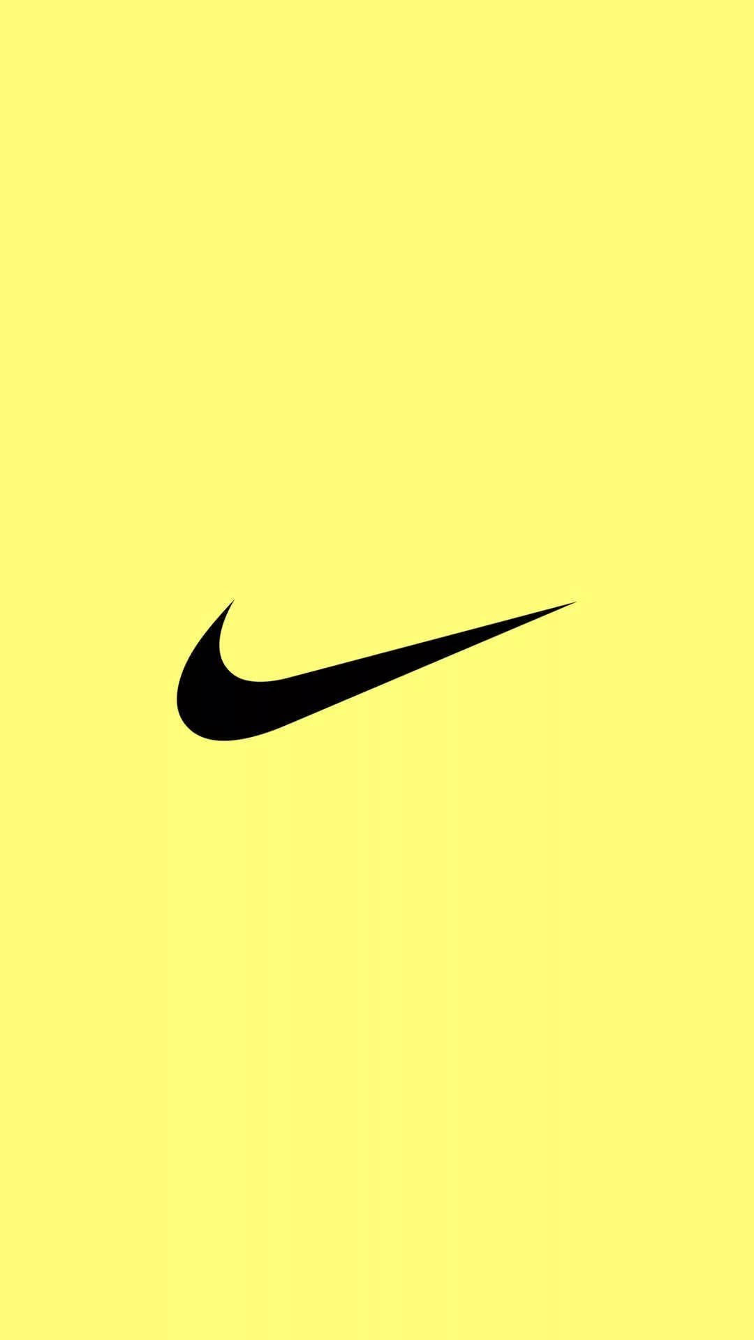 耐克 iPhone 黃色背景 壁紙 — 一個大膽的黑色Nike Swoosh標誌，居中於純亮黃色背景上。