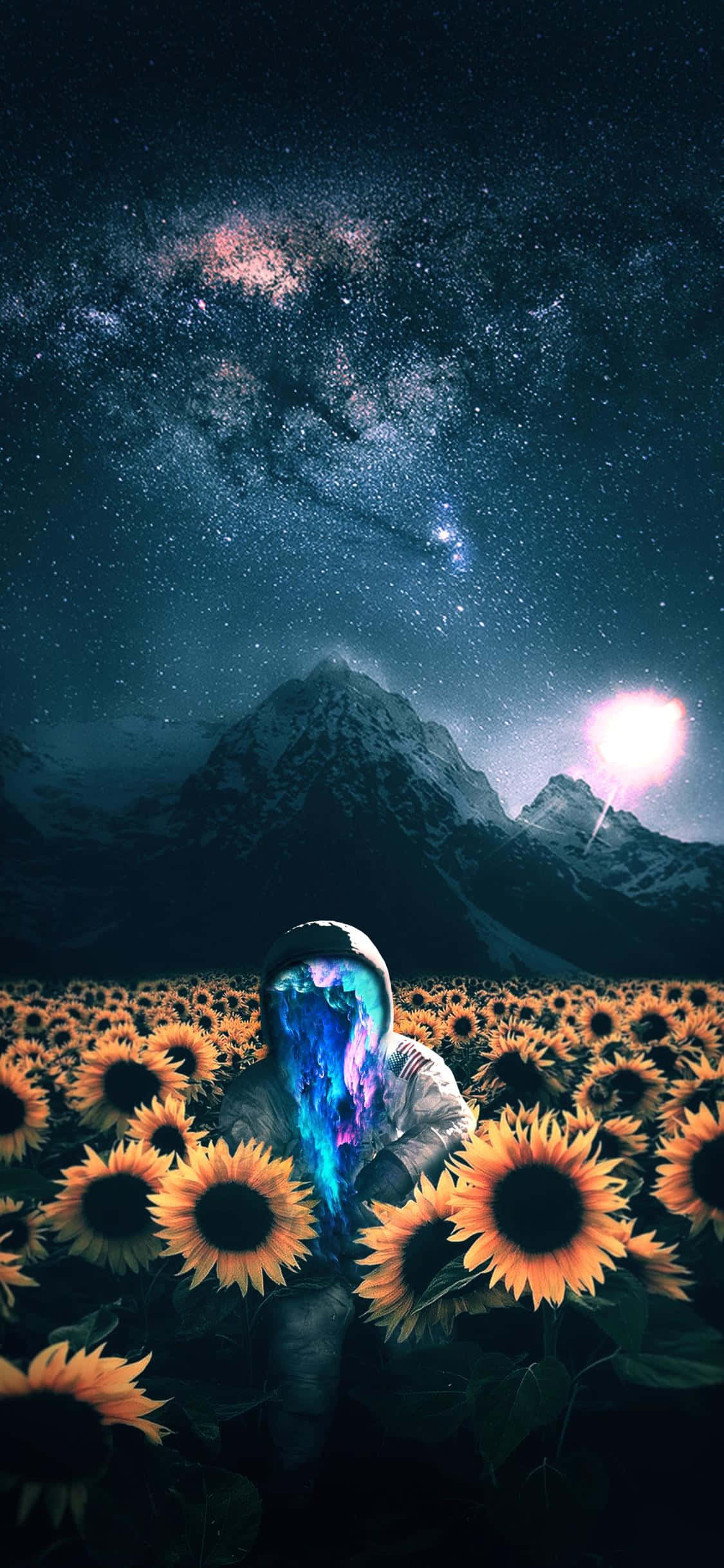 國際太空站宇航員玩iPhone Pong遊戲 壁紙 — 一個擁有發光宇宙頭髮的人物站在向日葵田裡，下方是星空，上方有明亮的天體和積雪的山峰。